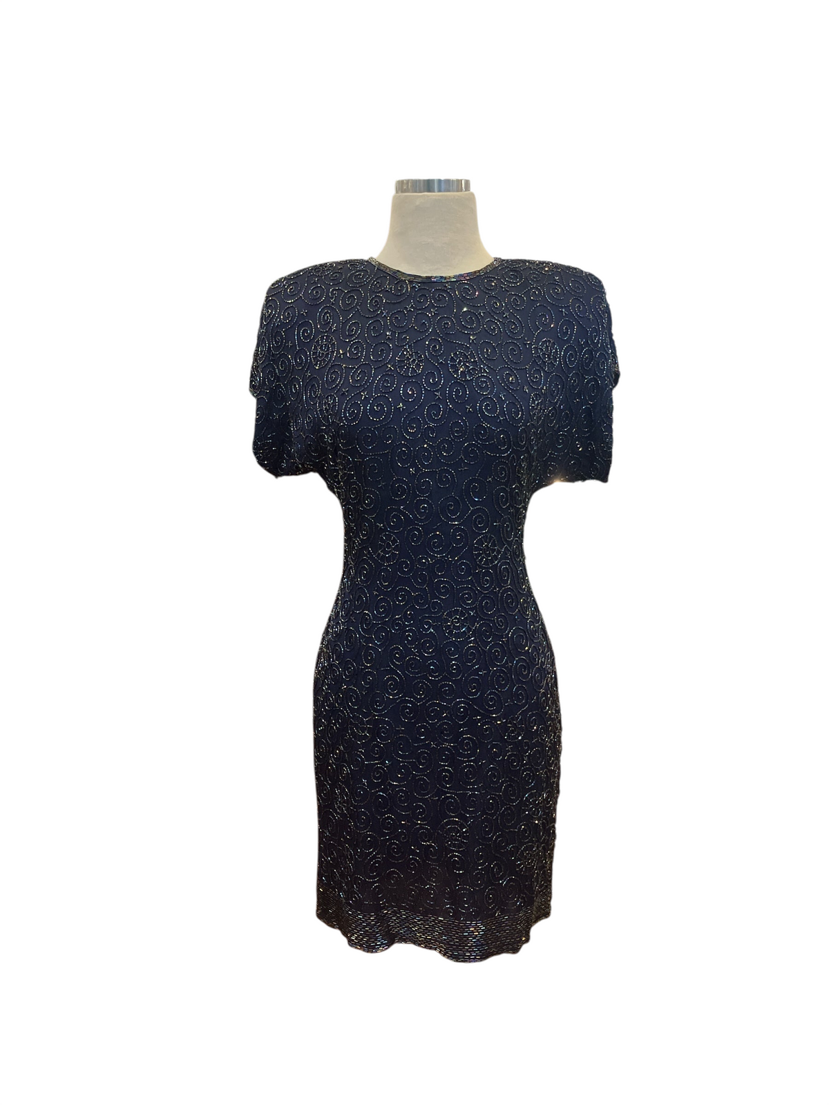 Amorin Vintage navy blue short sleeve cocktail dress with intricate swirling beadwork on a mannequin in a boutique.